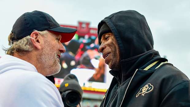 Nov 25, 2023; Salt Lake City, Utah, USA; Colorado Buffaloes head coach Deion 'Coach Prime' Sanders congratulates Utah Utes head coach Kyle Whittingham after the Utah Utes victory over the Colorado Buffaloes at Rice-Eccles Stadium. Mandatory Credit: Christopher Creveling-USA TODAY Sports